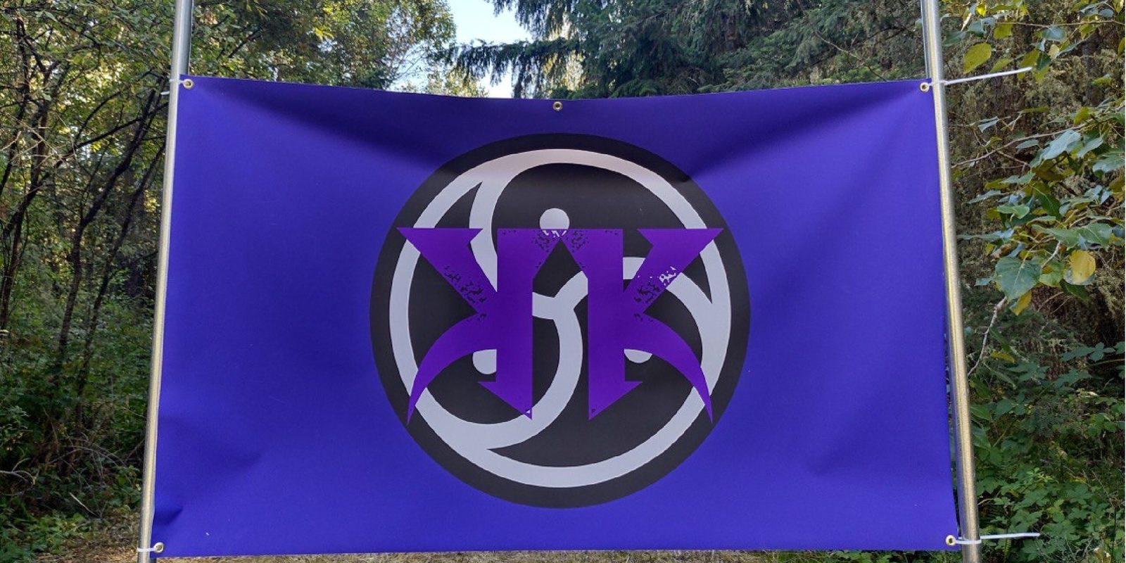 Kinky Kamping banner hanging in the forest